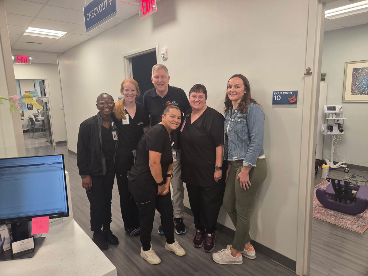 medical-office-corporate-massages Ricky pictured with medical staff in a medical office for corporate massages
